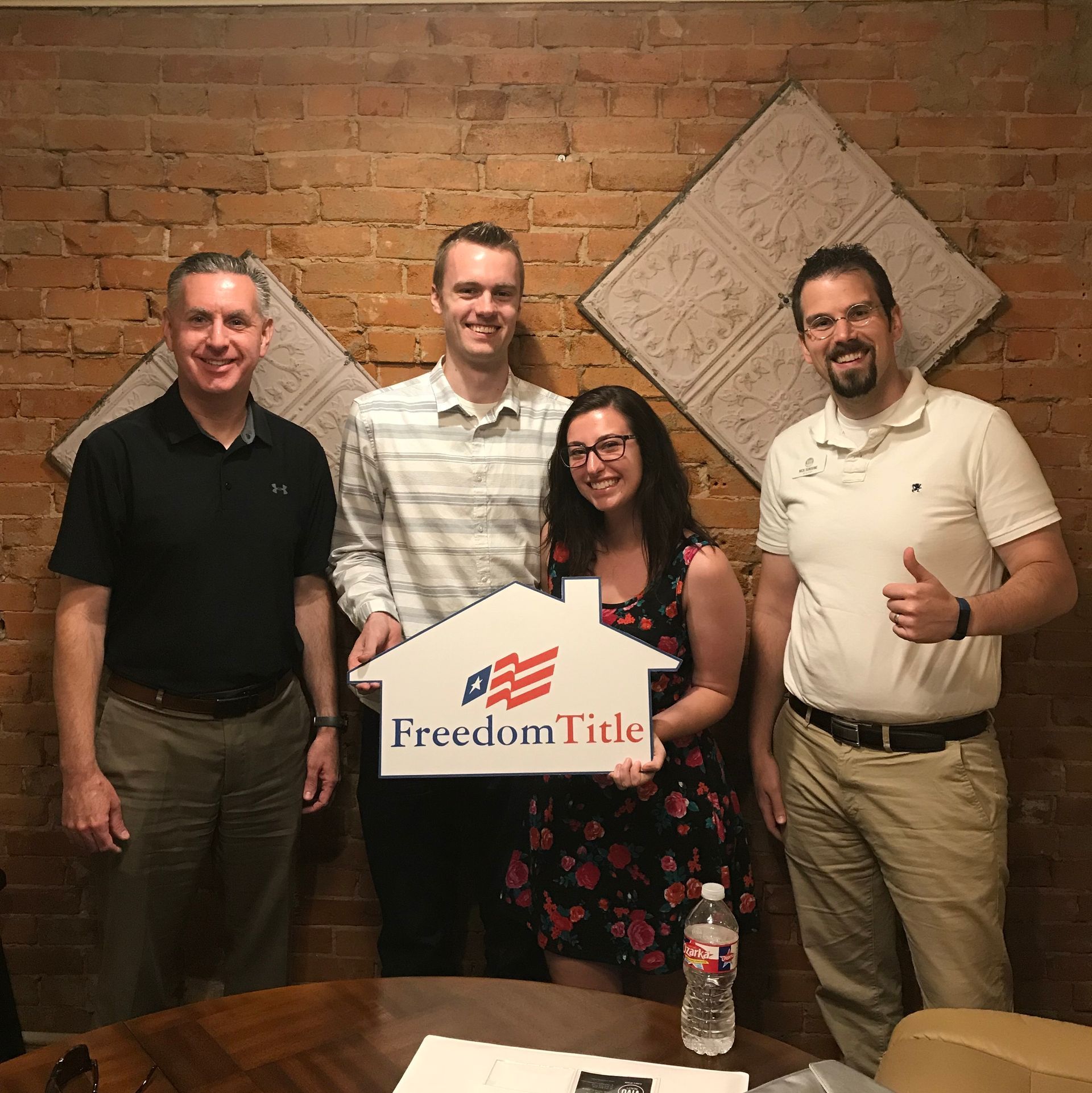 A little girl is holding a bunch of keys in front of her parents.