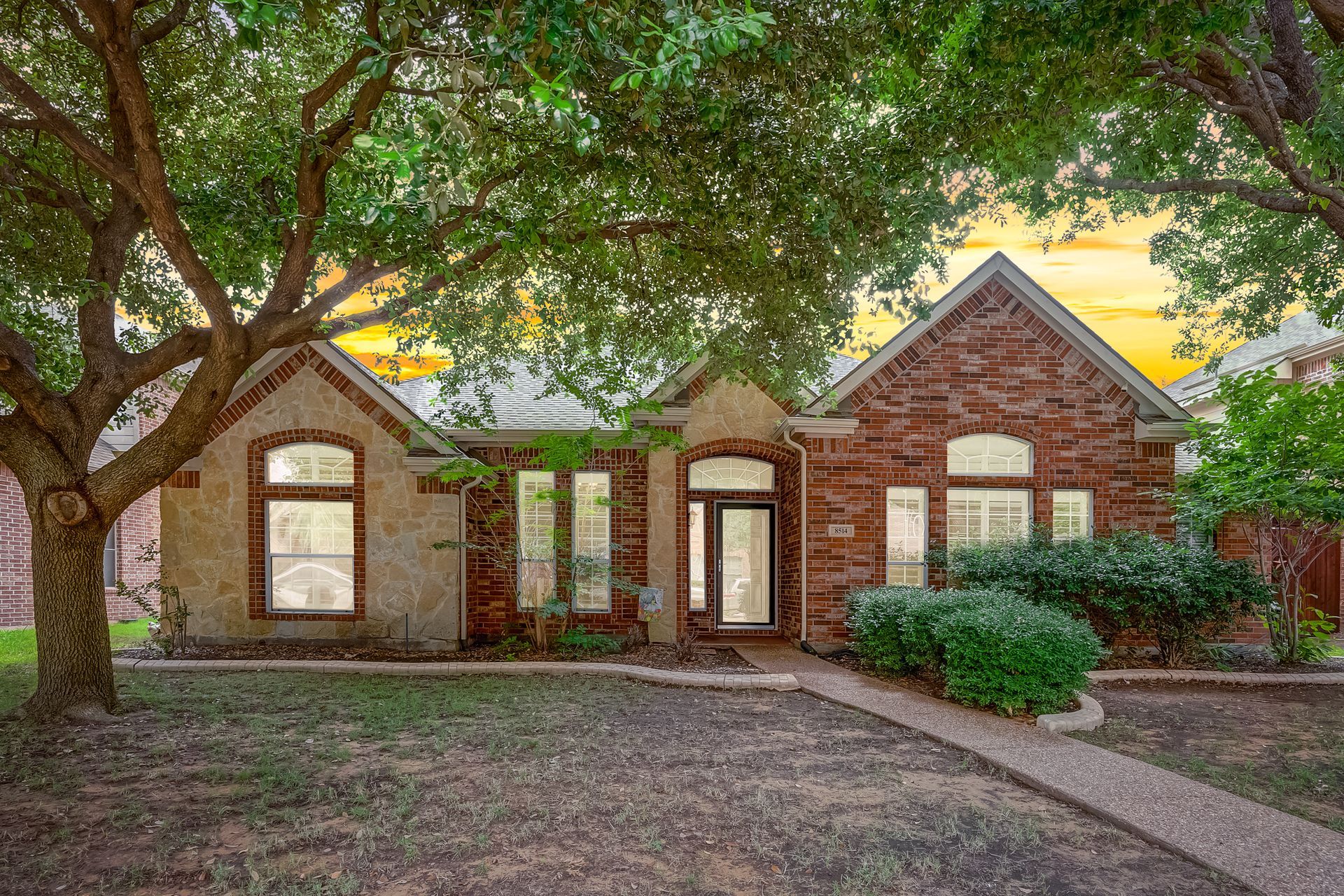 A large covered patio with furniture and a ceiling fan.