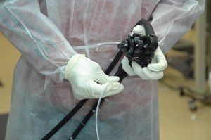 Cancer Screening — Doctor Holding Endoscope Preparing For Patient Surgeon in Louisville, KY