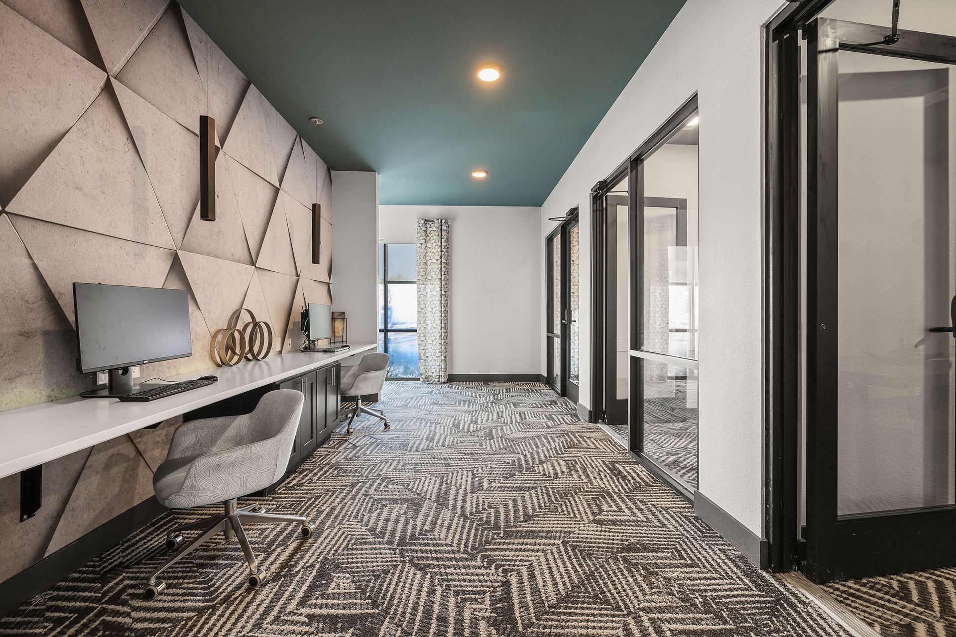 An artist's impression of an apartment community cyber cafe hallway with a computer desk and chairs at The Heights offers student apartments in Huntsville, TX.