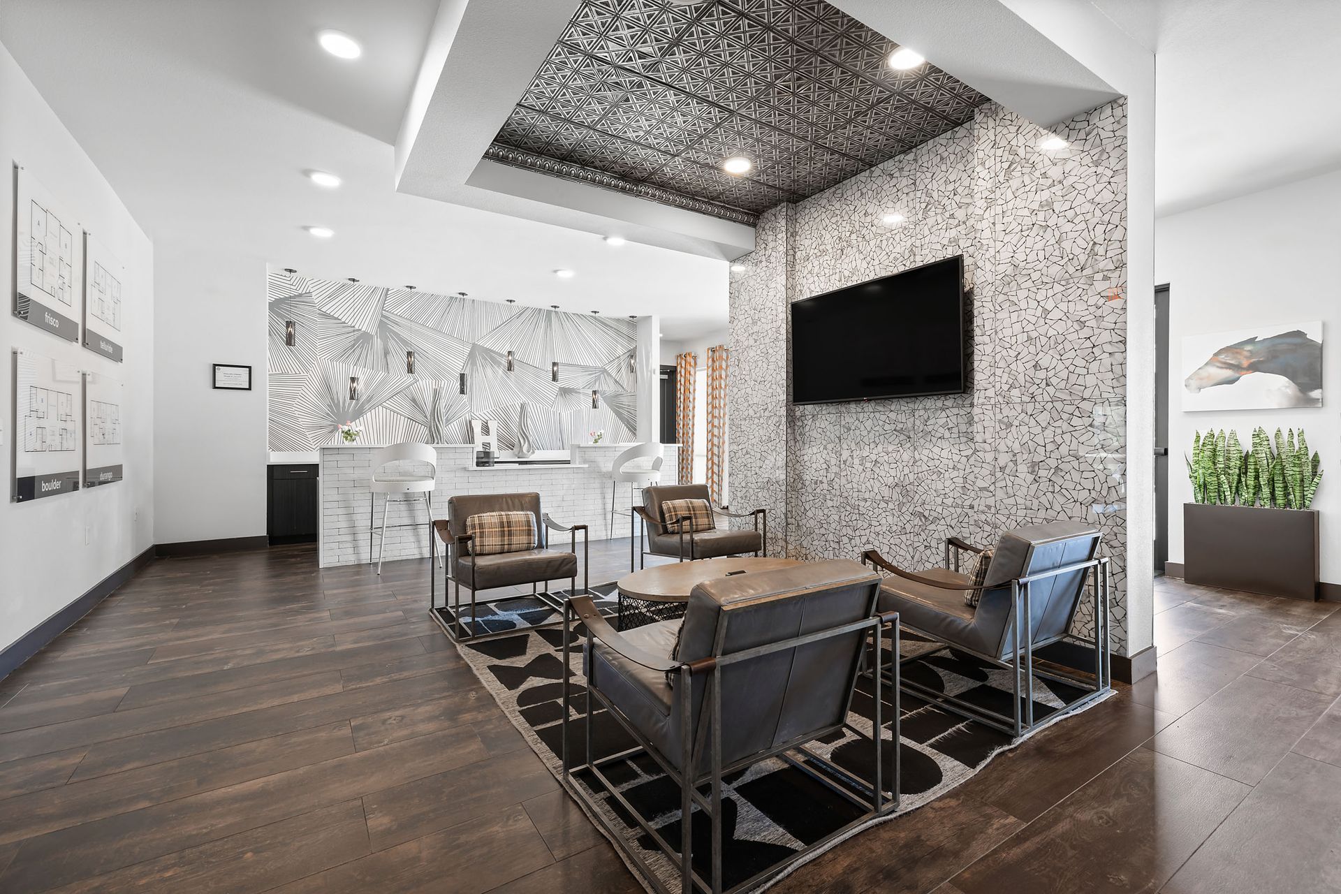 Apartment leasing office filled with furniture and a flat-screen TV at The Heights offers student apartments for rent in Huntsville, TX.