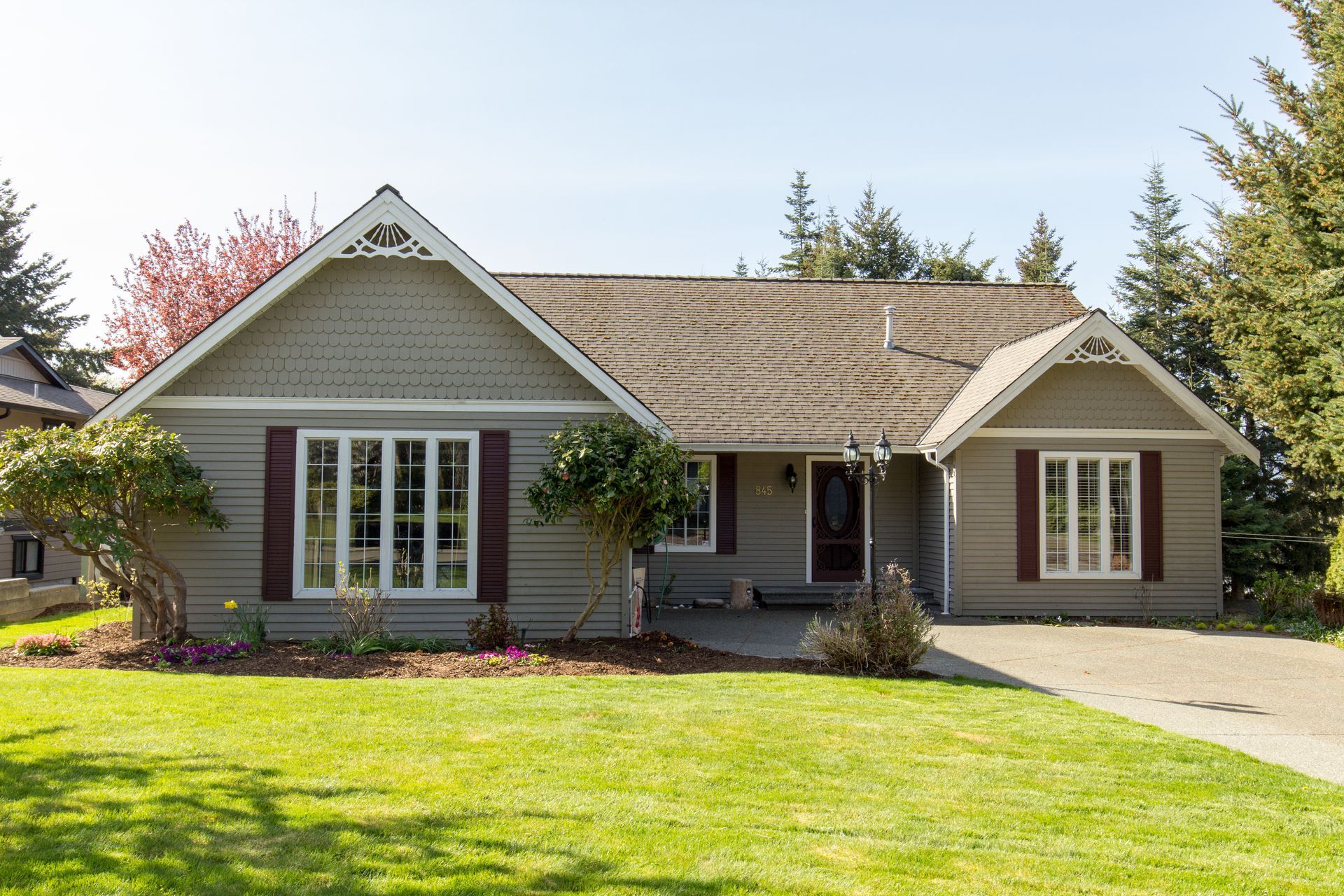 A house with a large lawn in front of it