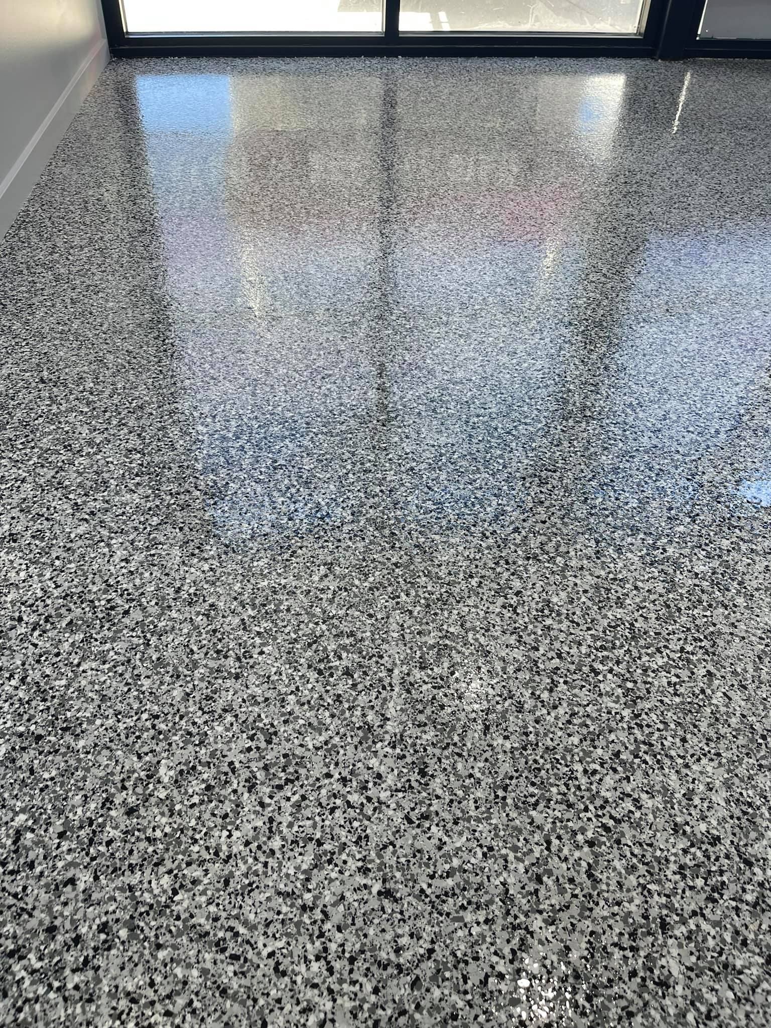 A close up of a shiny concrete floor in a room.