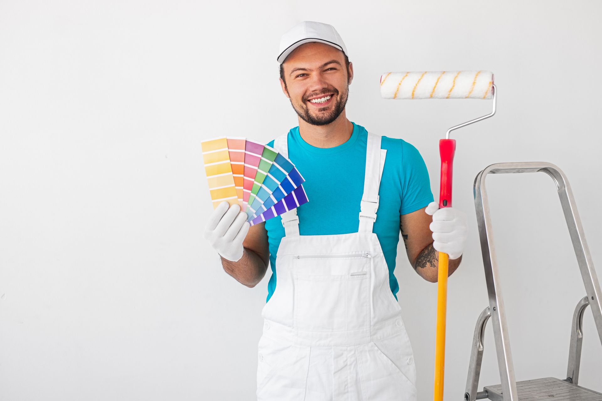 A cheerful painter holding a colour palette and a paint roller.