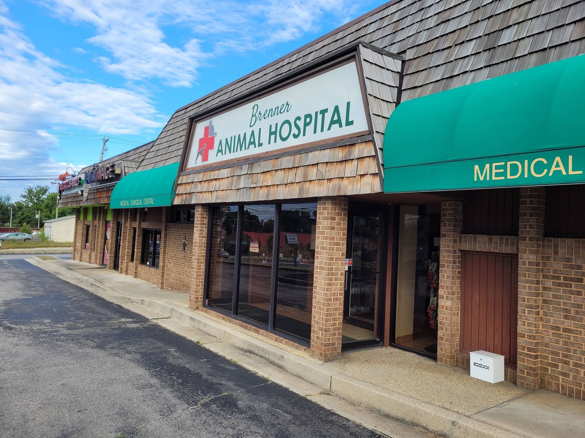 A large brick building with a sign that says animal hospital on it.