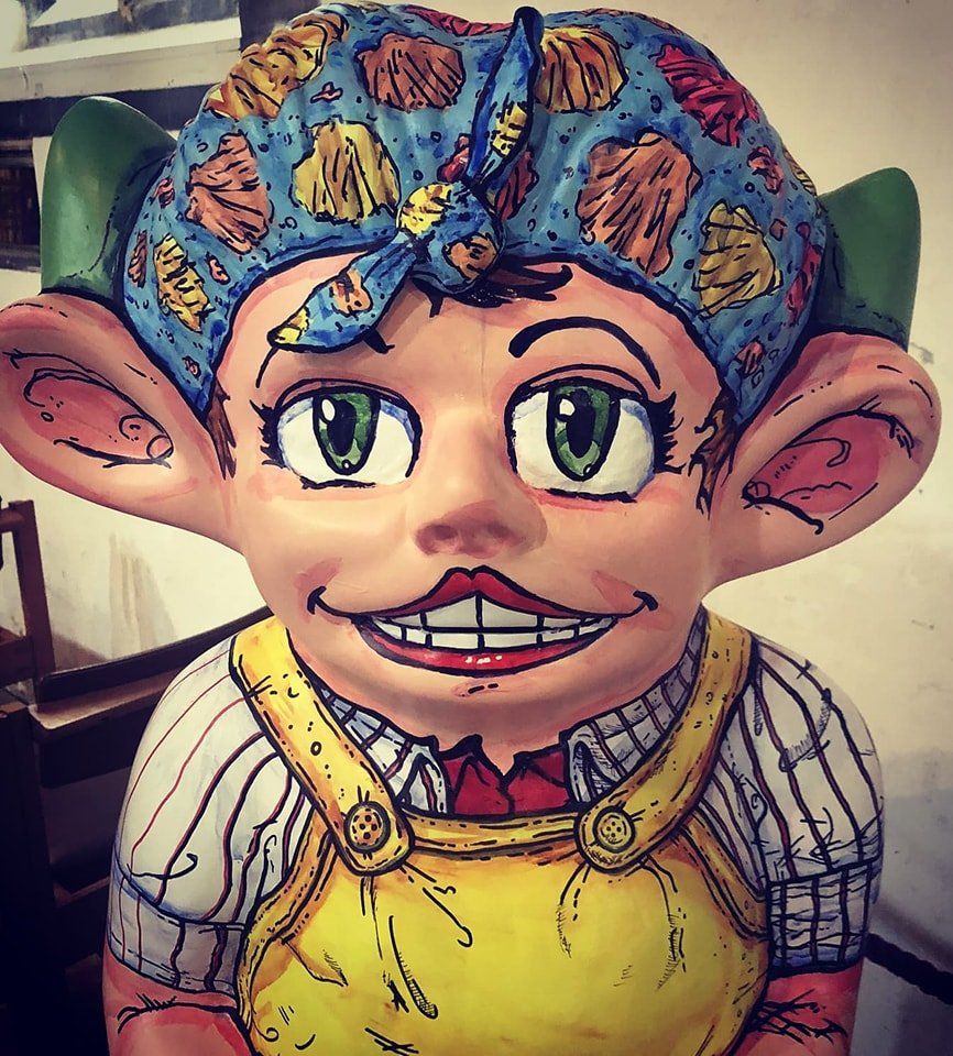 A cartoon character wearing a blue headband and overalls