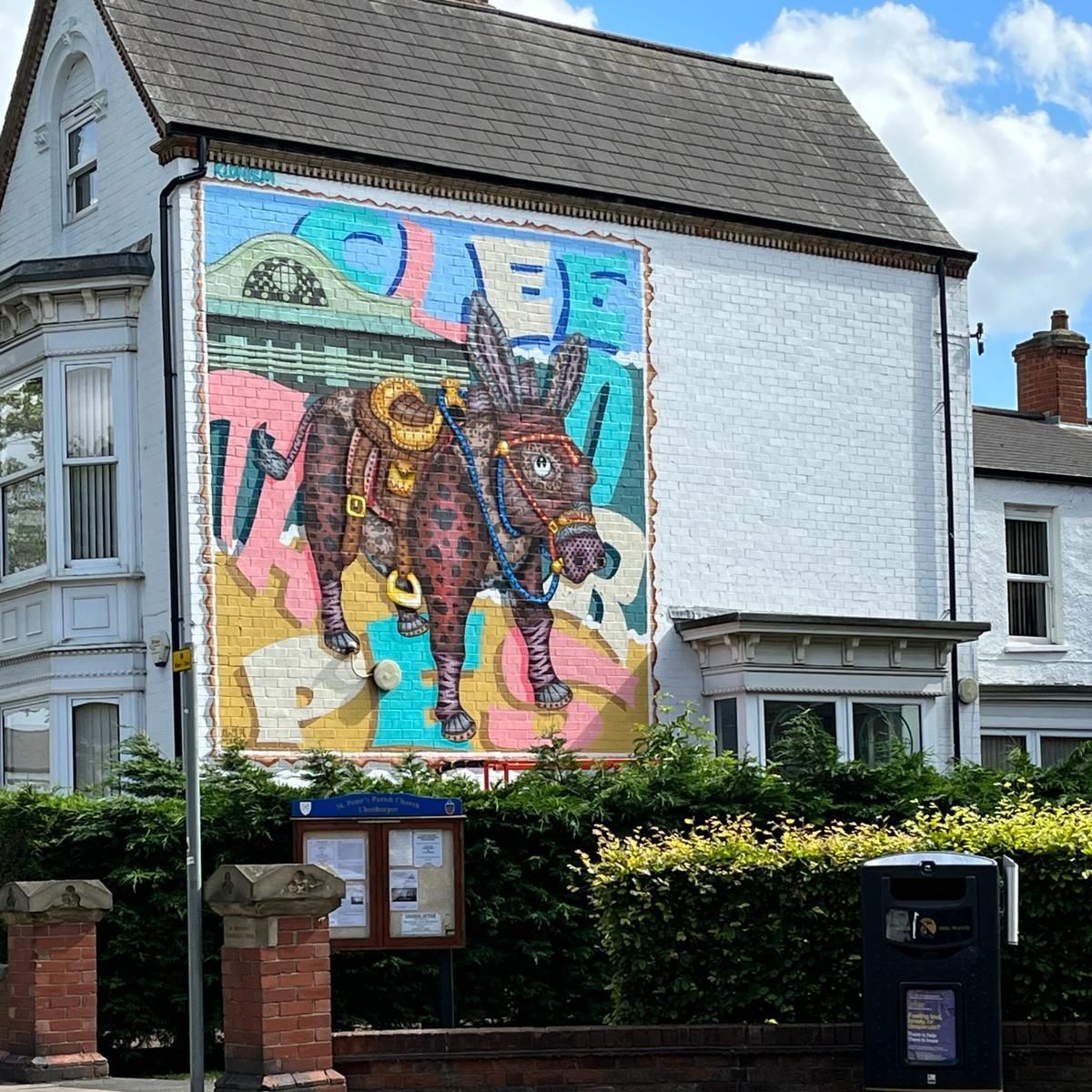 A painting of a donkey on the side of a building