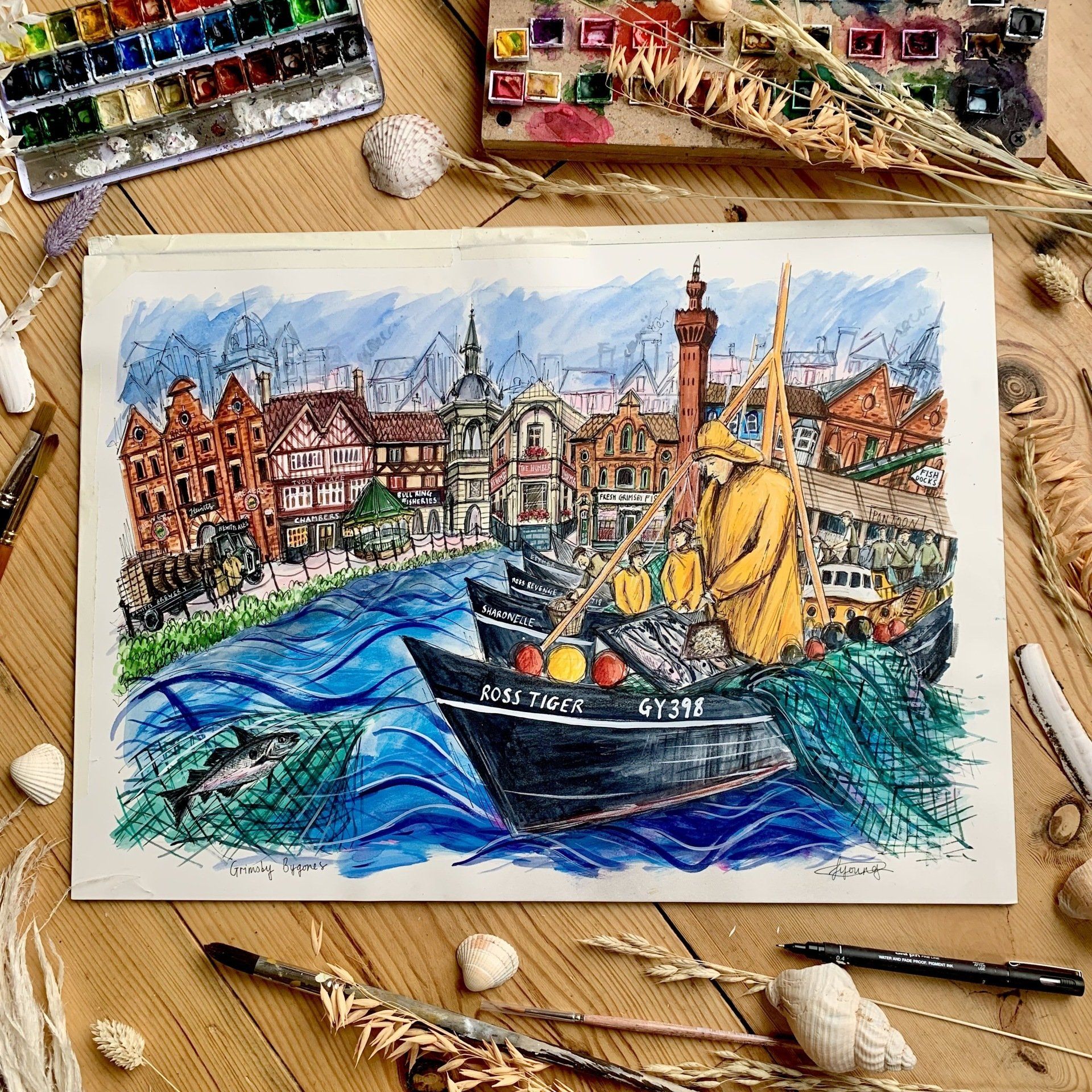 A painting of a man in a boat is sitting on a wooden table.