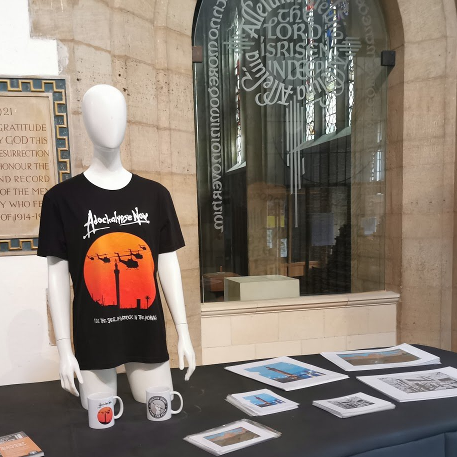 A mannequin wearing a black t-shirt with a sunset on it