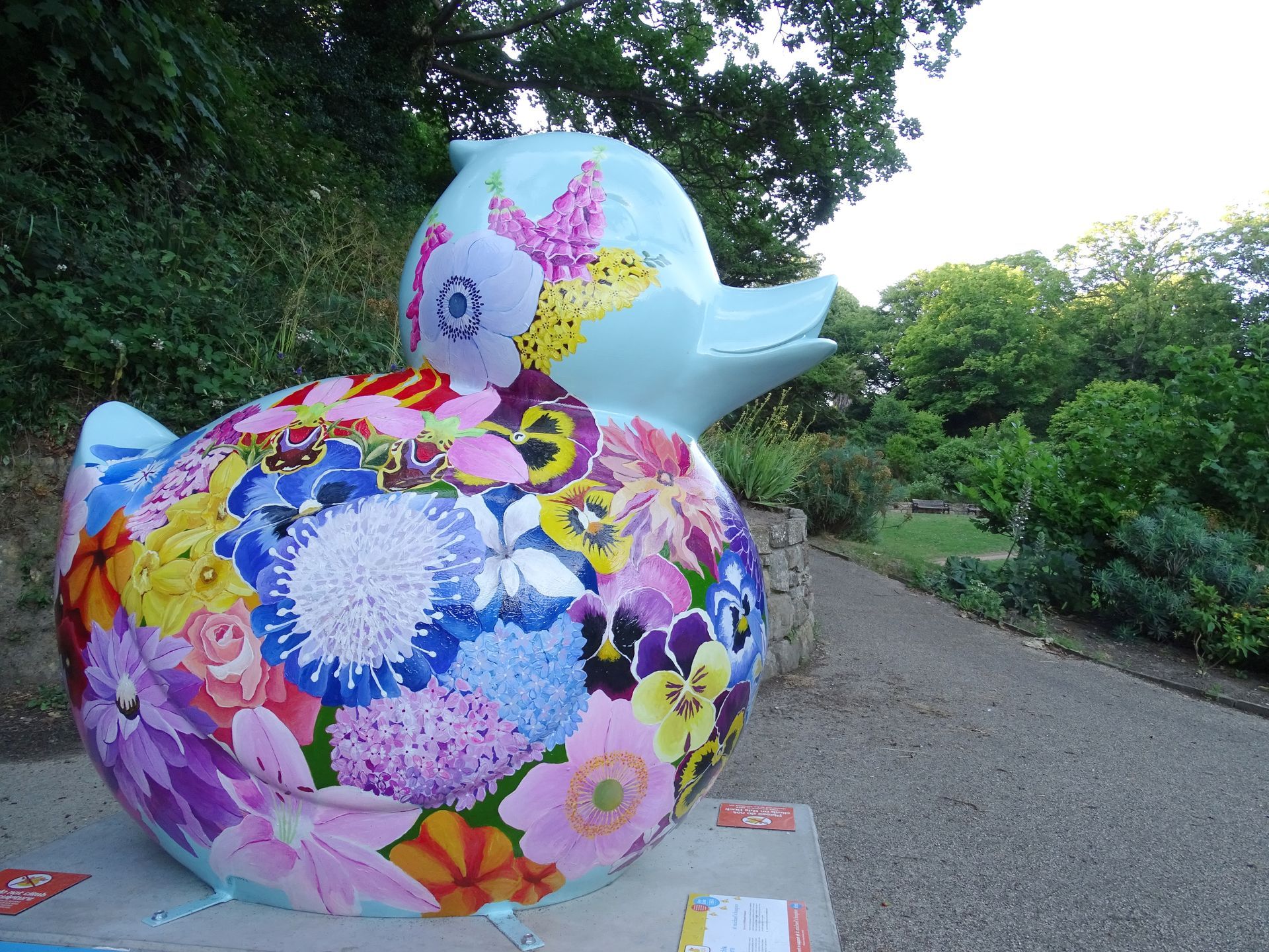 A blue duck with flowers painted on it