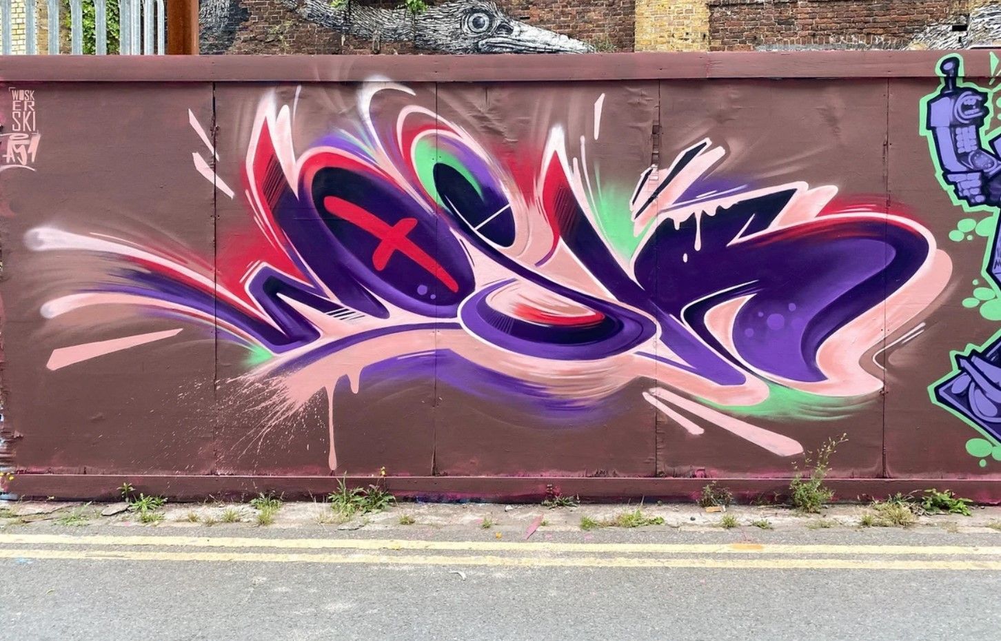 A wall with graffiti on it that says ' x ' on it