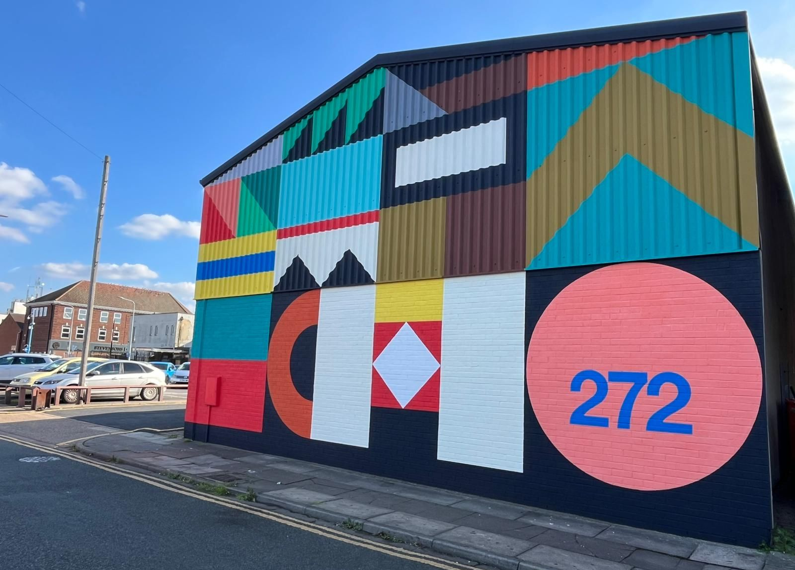 A colorful mural on a building, labeled 