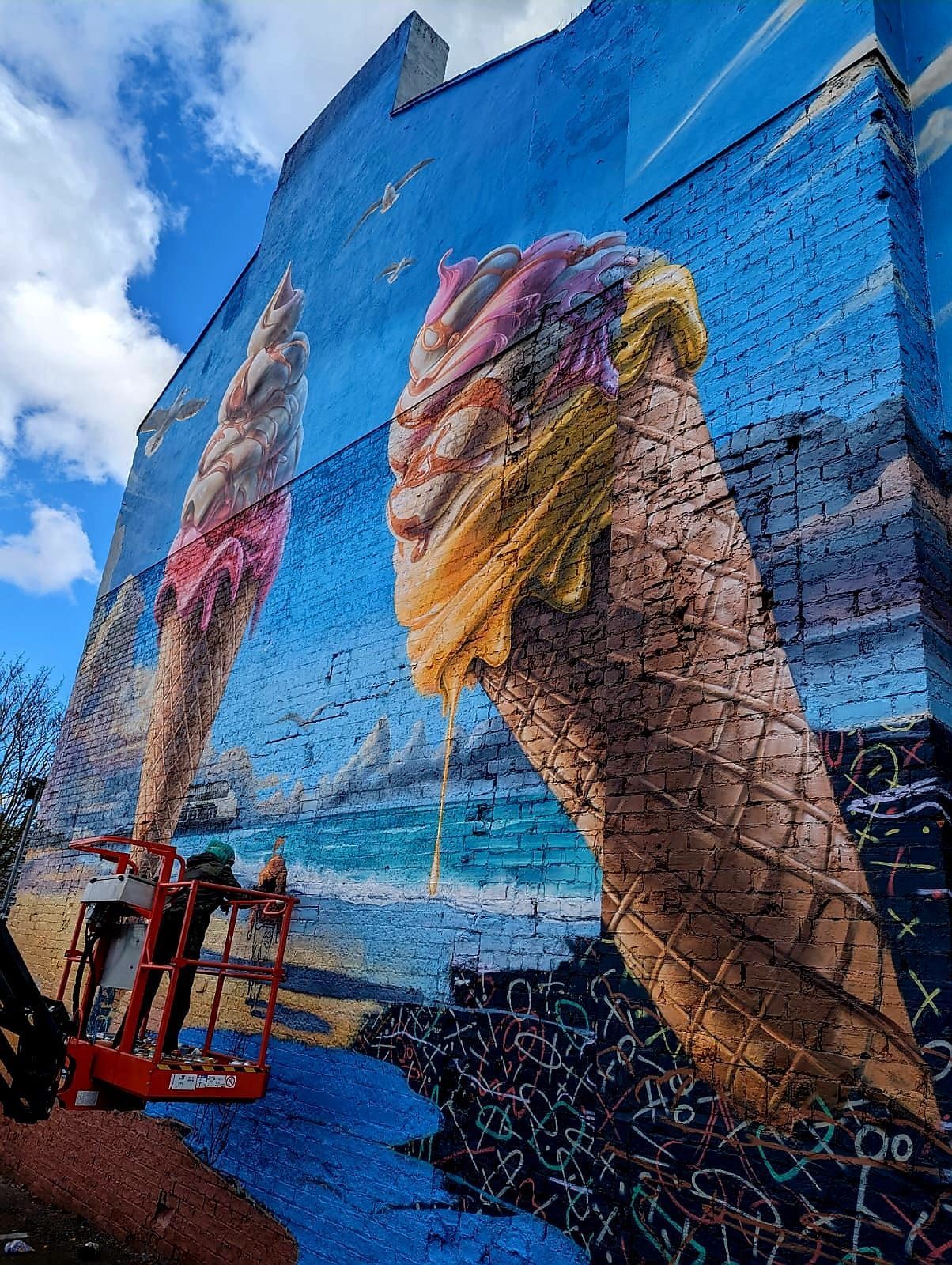 A large mural of ice cream cones on the side of a building.
