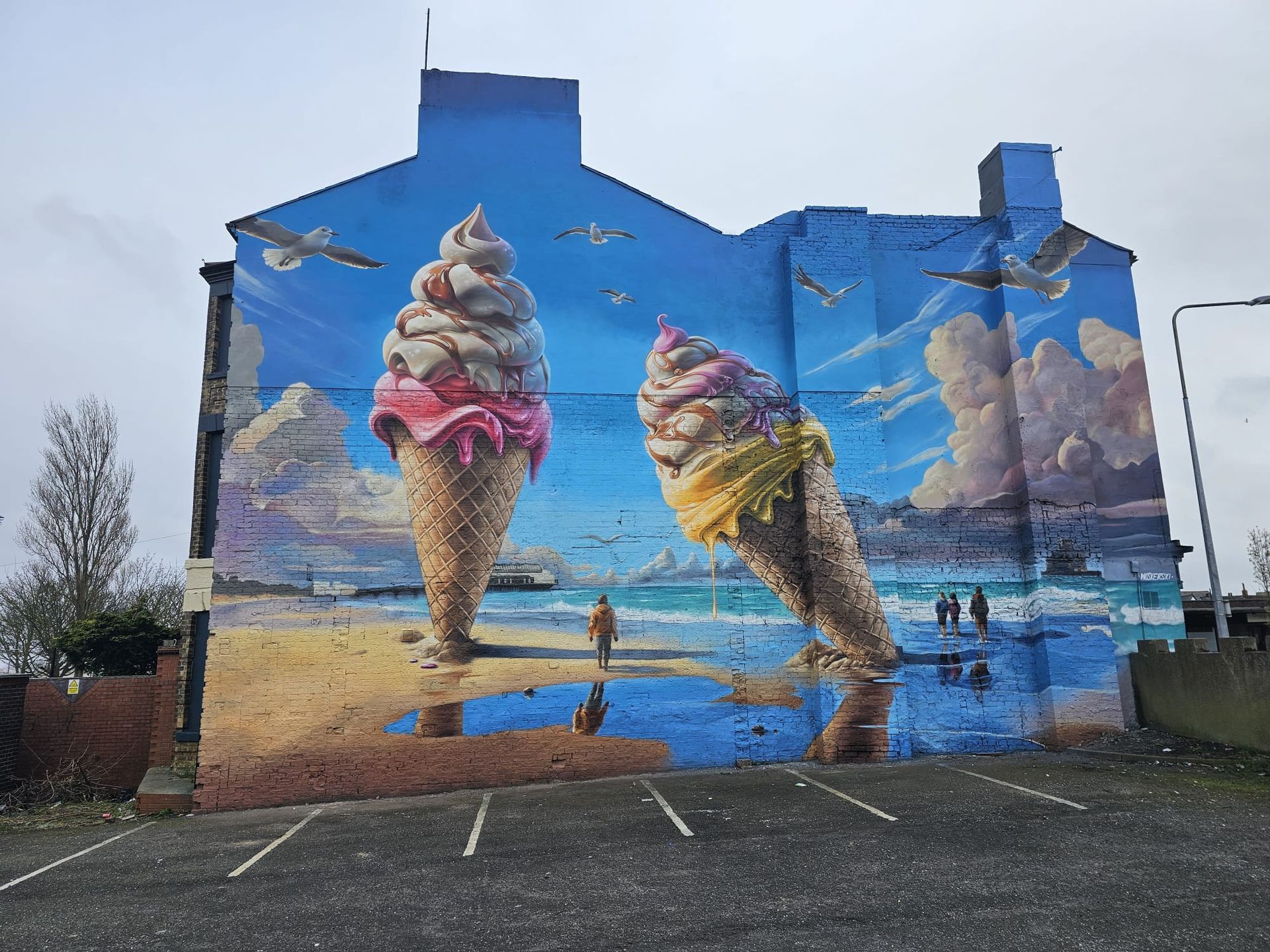 A large mural of two ice cream cones on the side of a building.