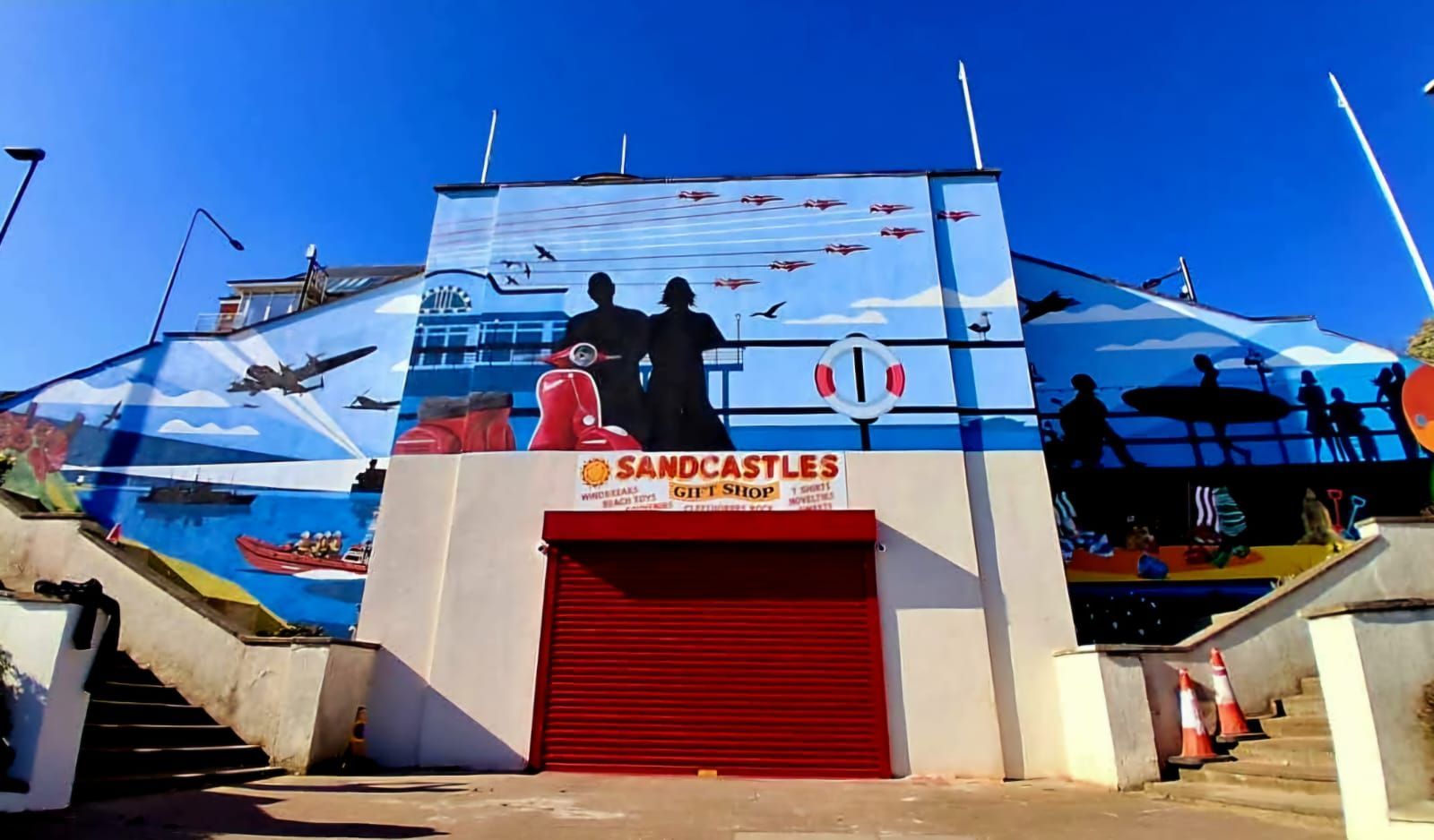 A building with a large mural on the side that says band-aids