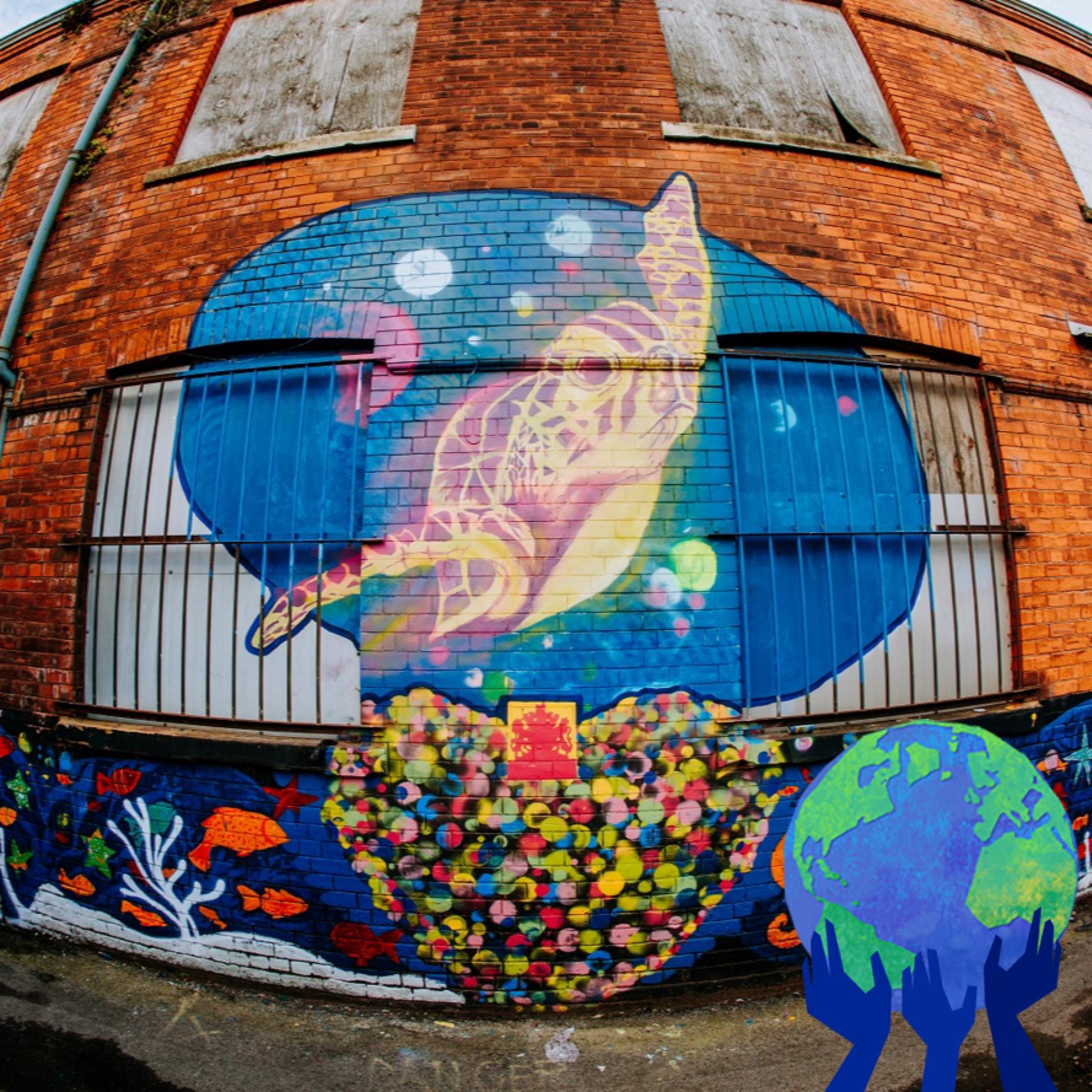A mural of a sea turtle on a brick wall