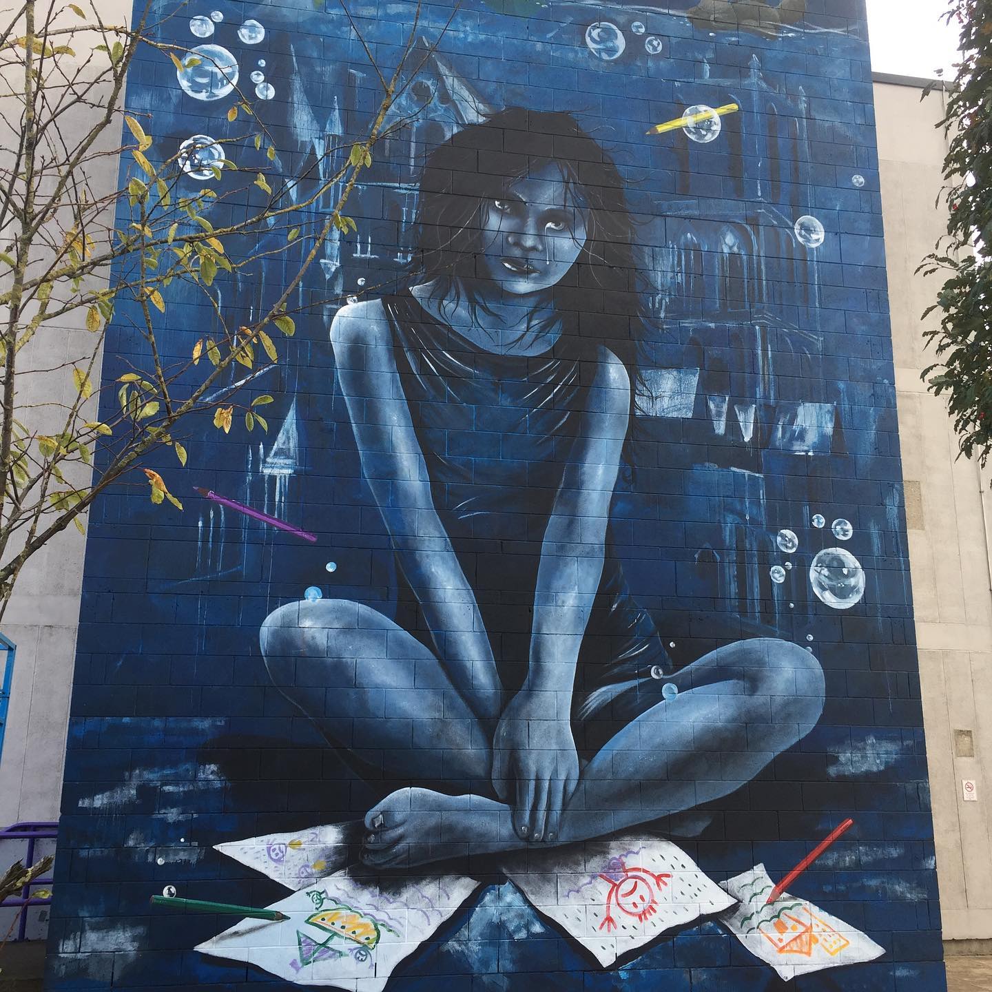 A mural of a woman sitting on a piece of paper