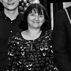 A man and a woman are posing for a picture in a black and white photo.