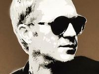 A black and white portrait of a man wearing sunglasses.