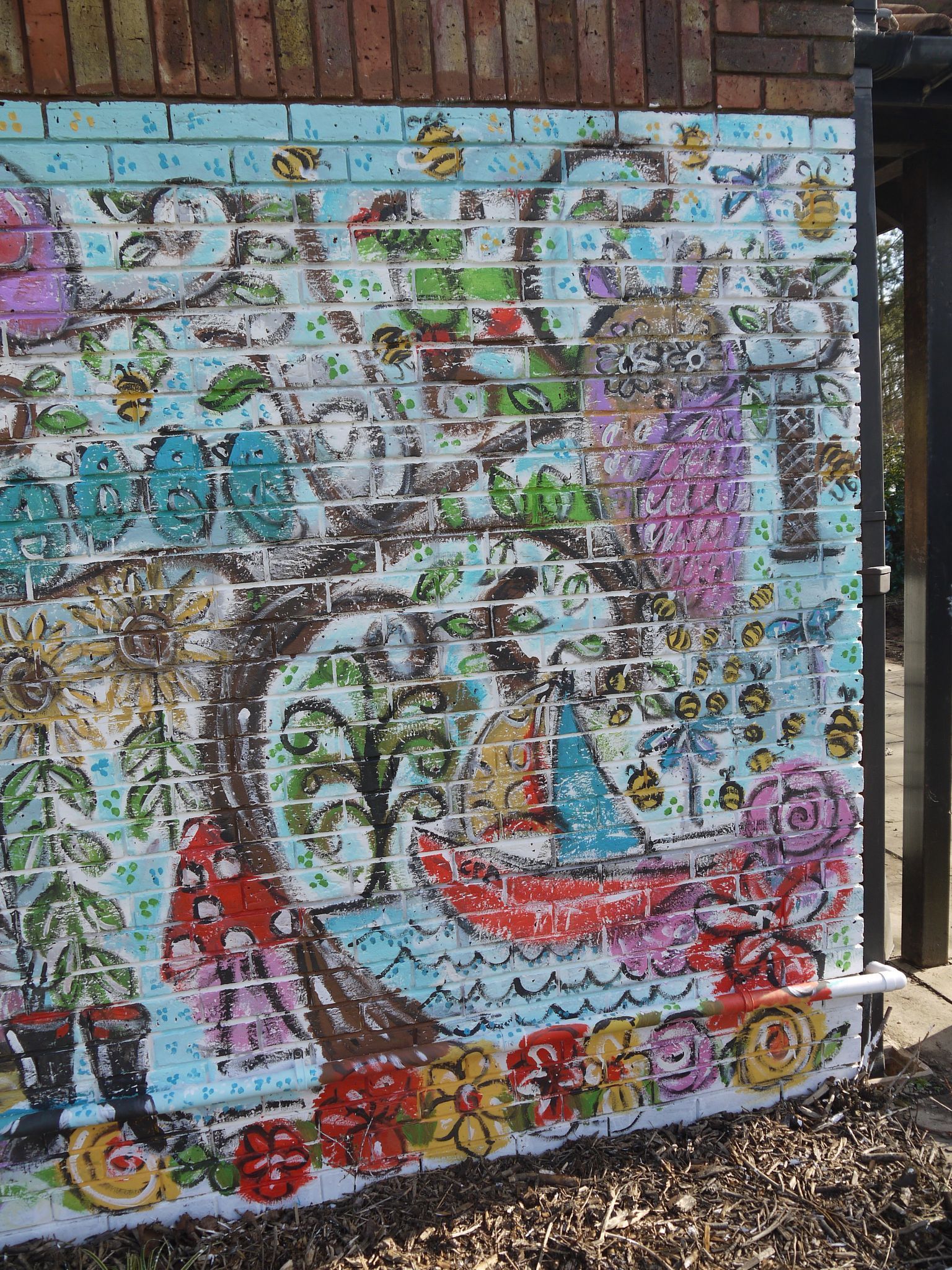 A brick wall with a colorful painting on it