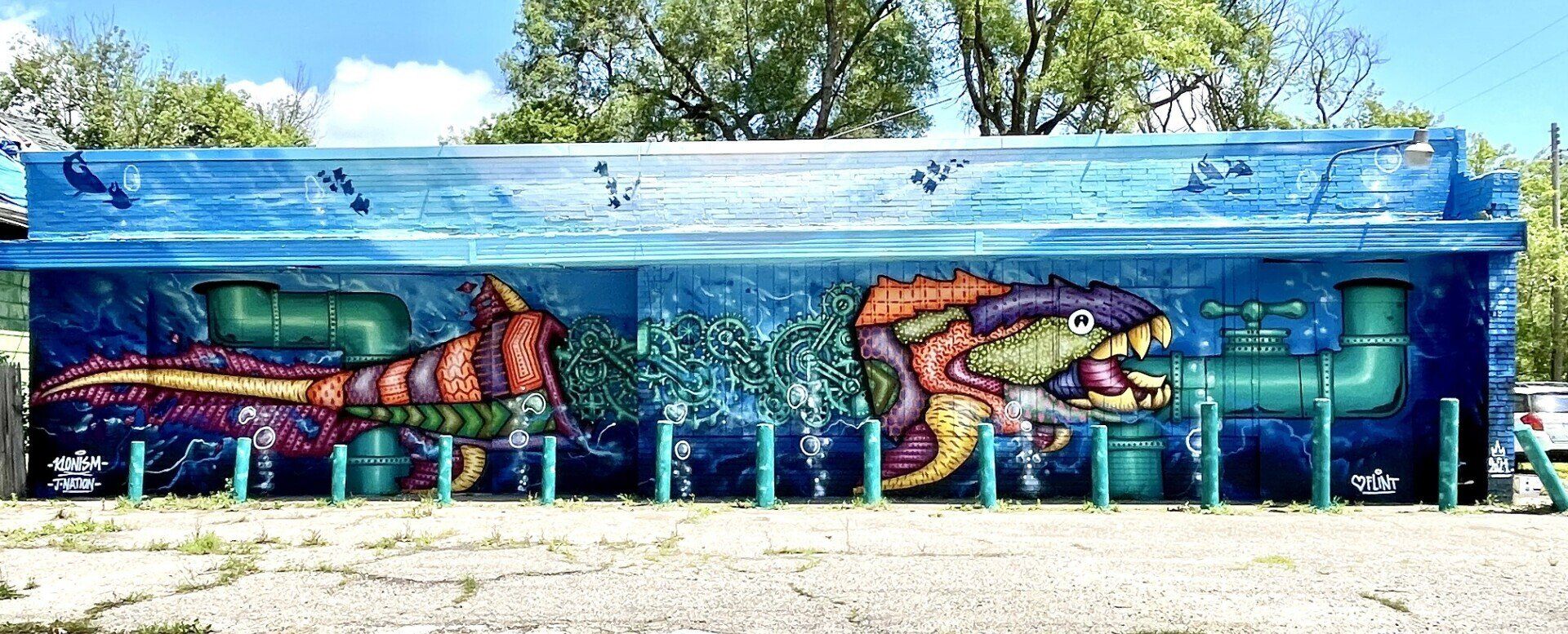 There is a large mural on the side of a building.