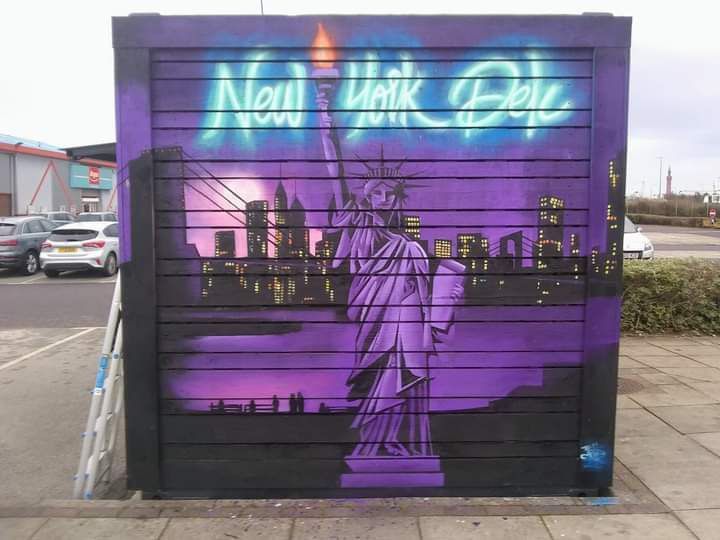 A purple and black mural of the statue of liberty in new york city