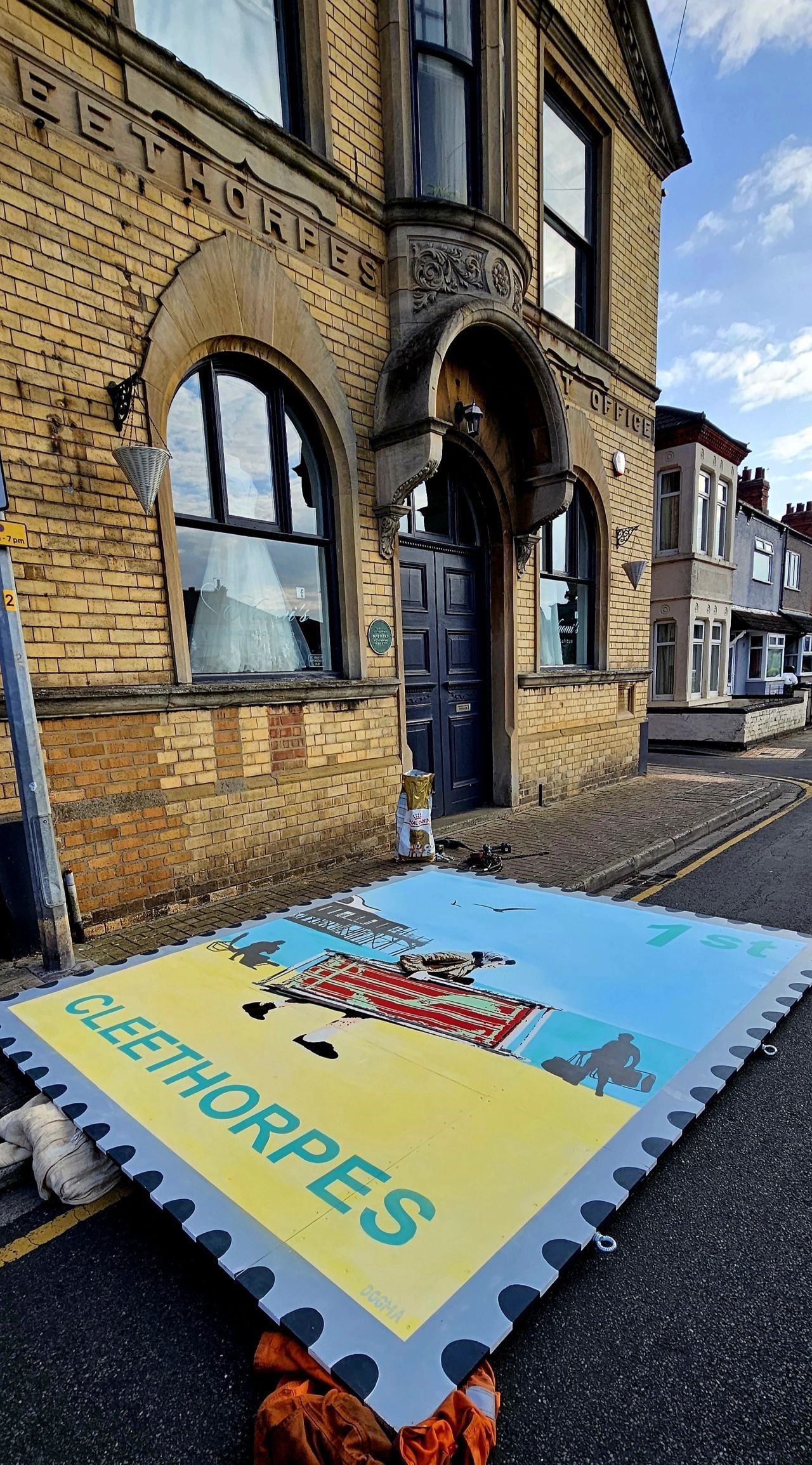 A large piece of paper with the word fleethorpes on it is sitting in front of a brick building.