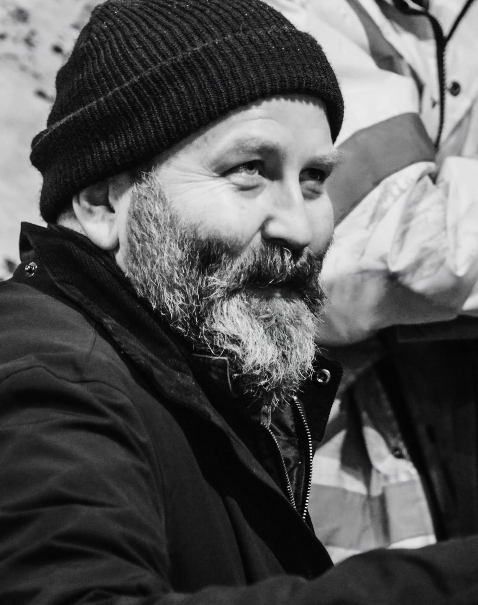 A man with a beard wearing a black beanie