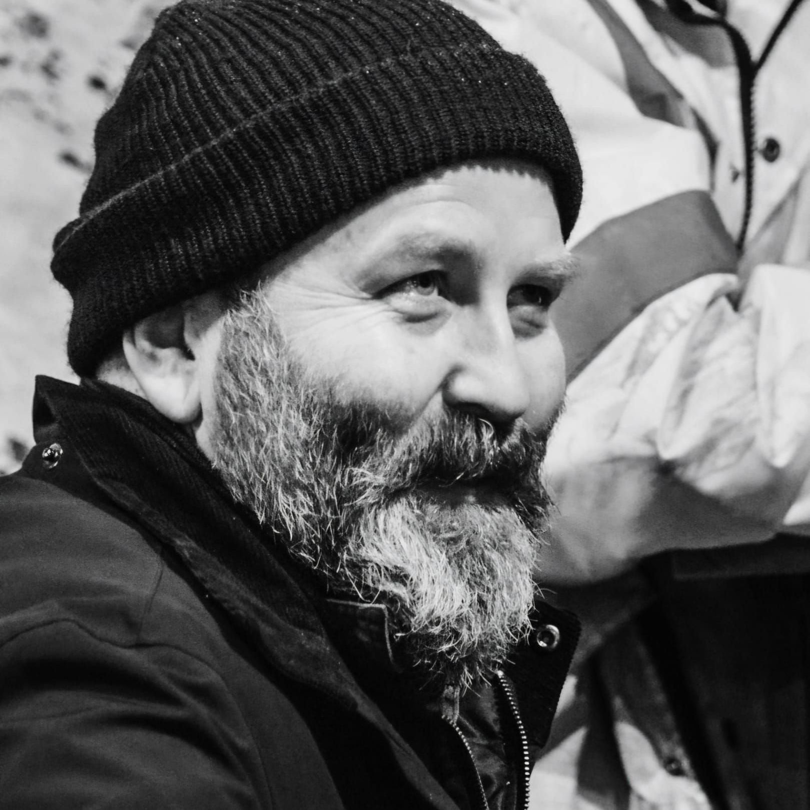 A man with a beard wearing a black beanie