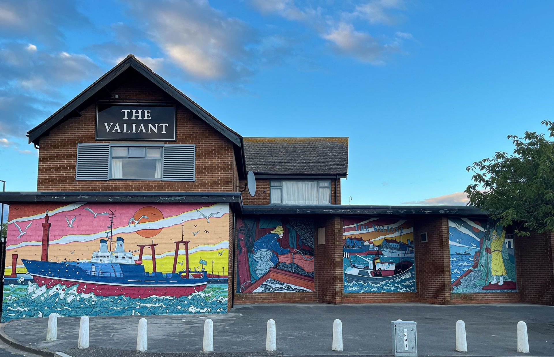 A building with a mural on the side of it that says the valiant