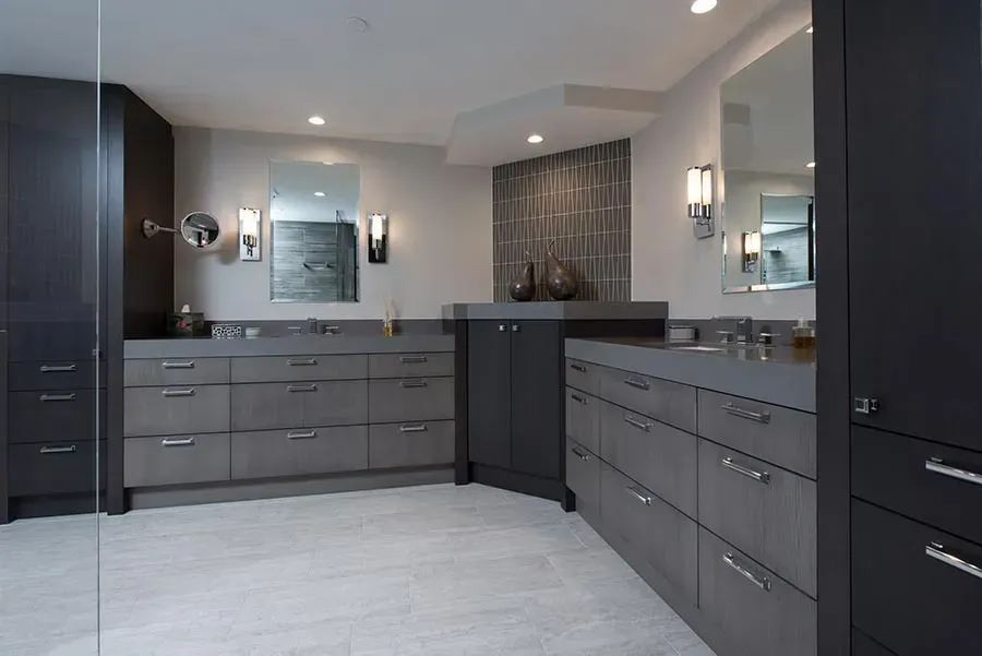 A bathroom with two sinks and a large mirror