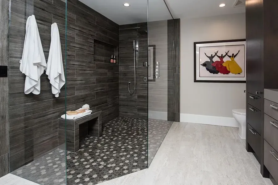 A bathroom with a walk in shower and a picture on the wall.
