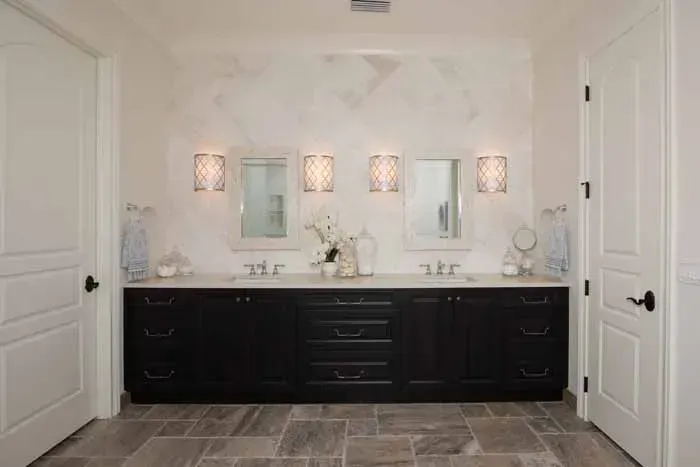 A bathroom with two sinks and two mirrors.