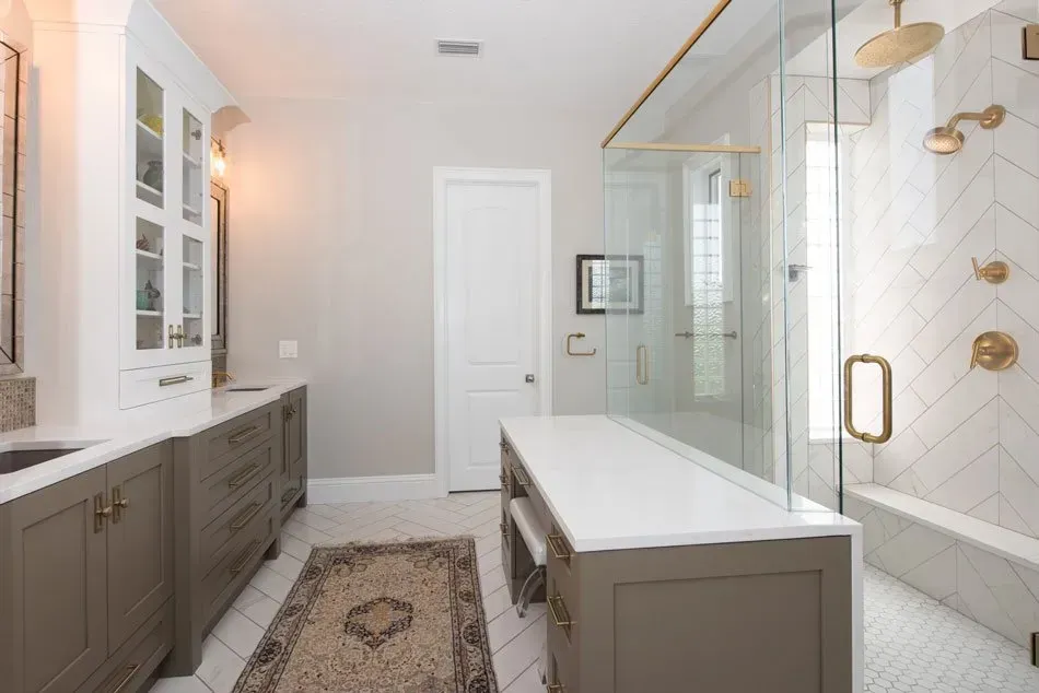 A bathroom with a walk in shower and two sinks.