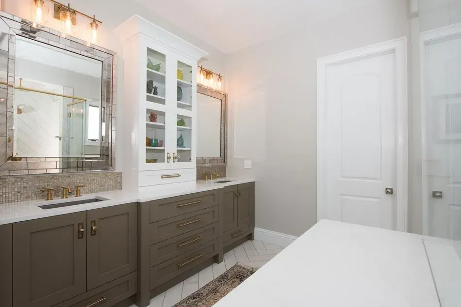 A bathroom with two sinks , two mirrors , and a large vanity.