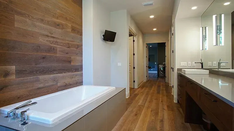 A bathroom with a bathtub and two sinks.