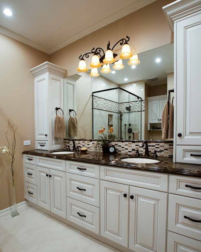 A bathroom with two sinks and a large mirror