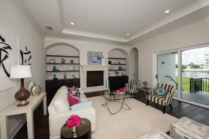 A living room with a couch , chairs , table and fireplace