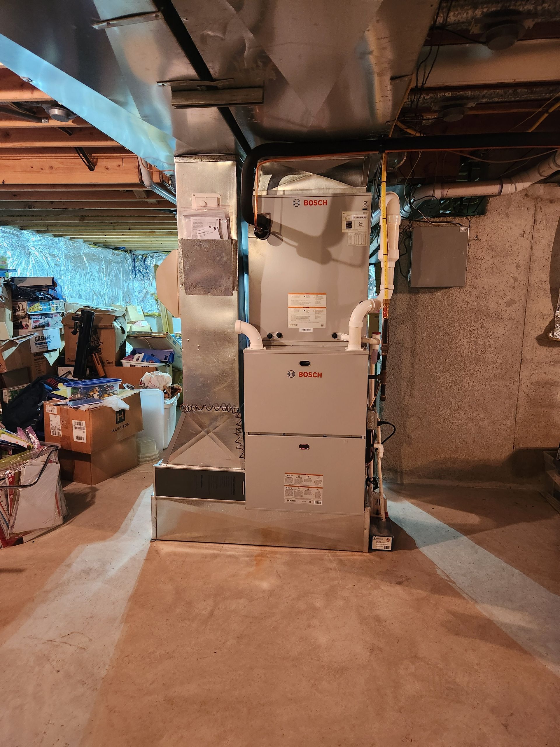 A heating and cooling system is installed in a basement.