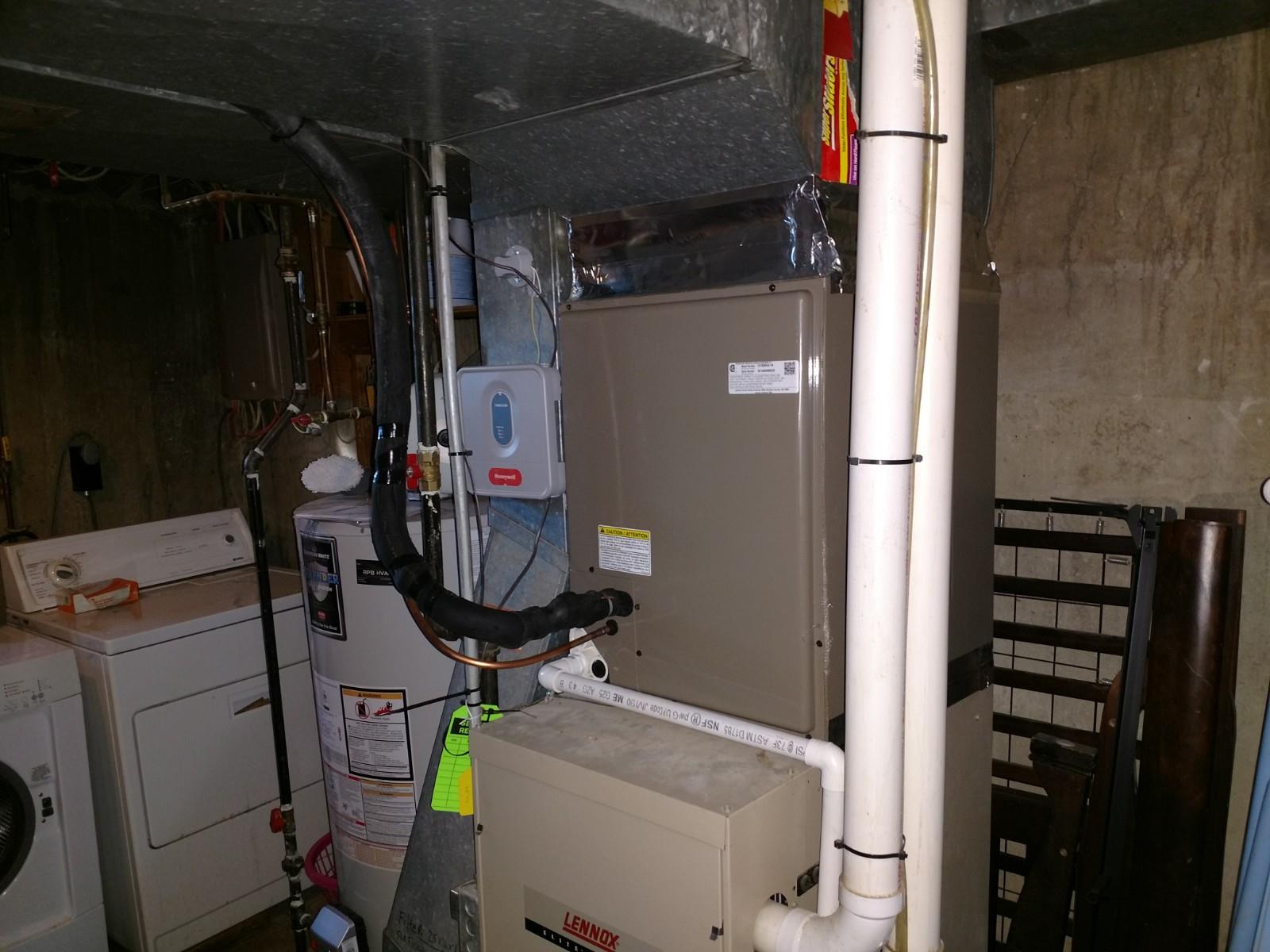 A basement with a washer and dryer and a furnace.