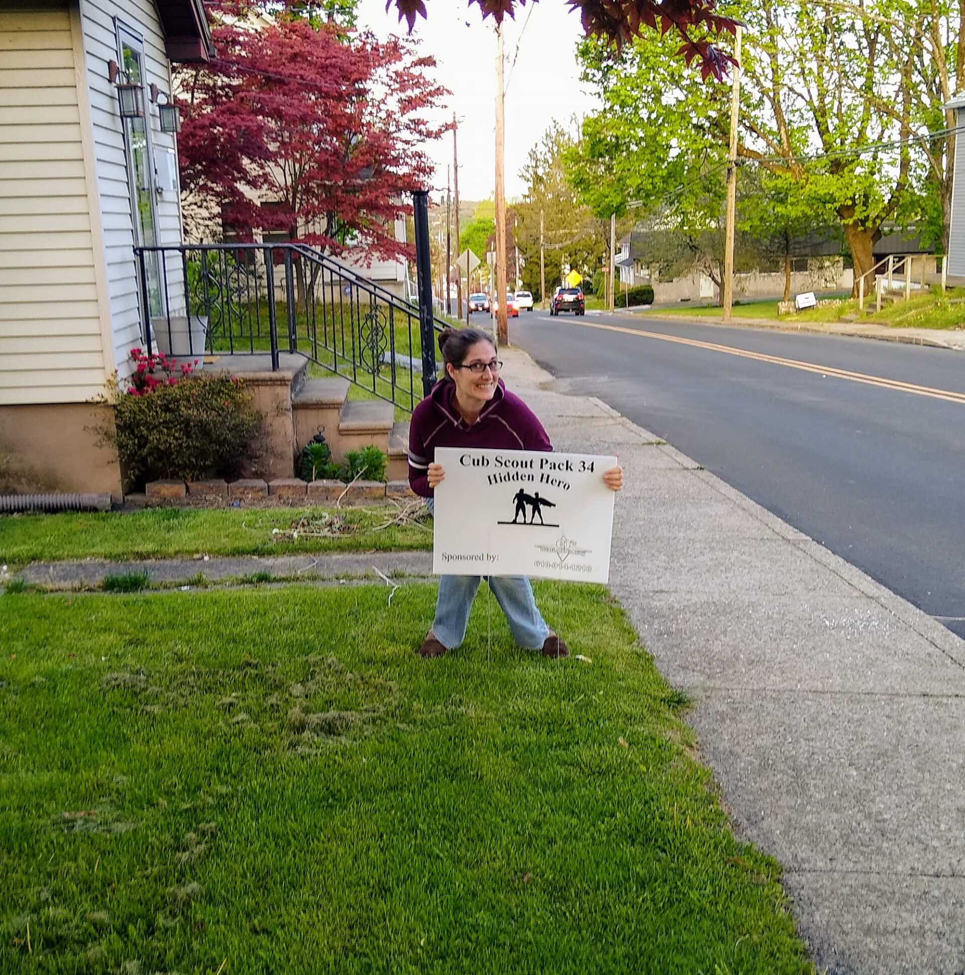 A woman holding a sign that says 