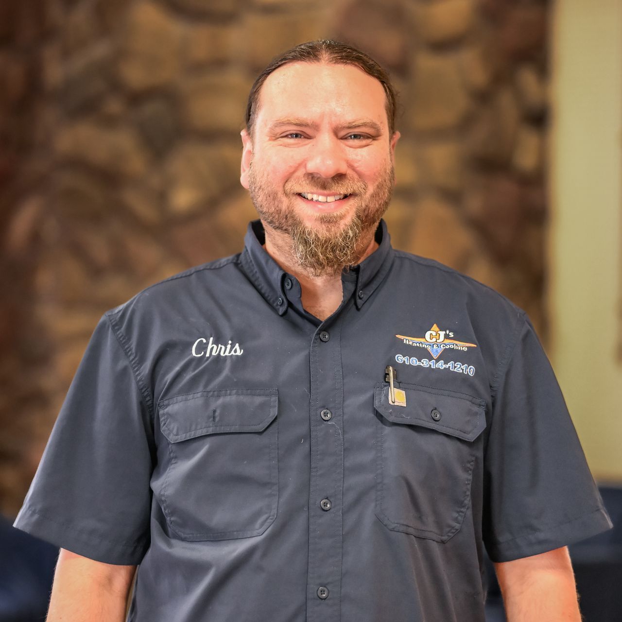 Chris from CJ's Heating and Cooling is standing in front of a van