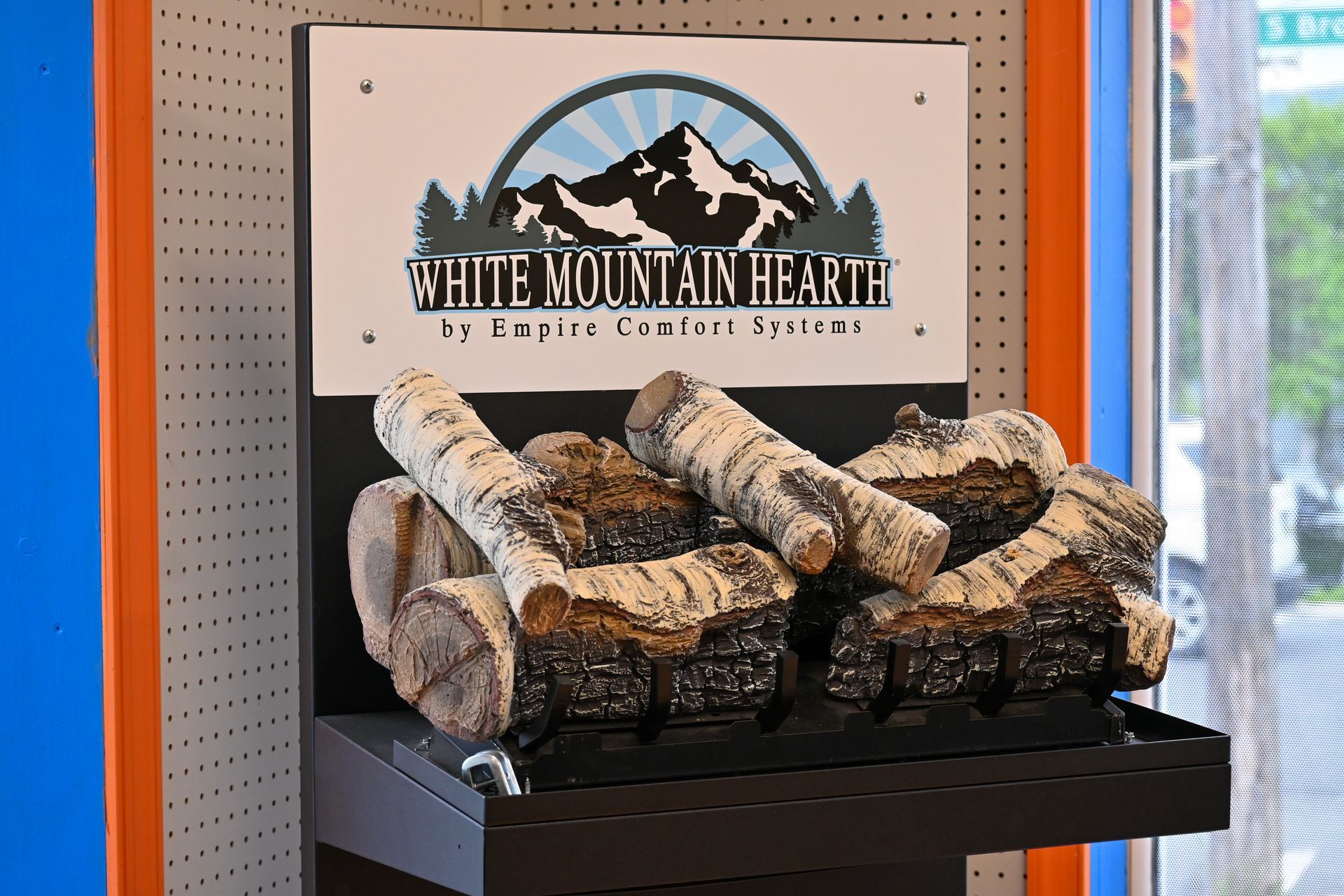 A display of logs with a sign that says white mountain hearth