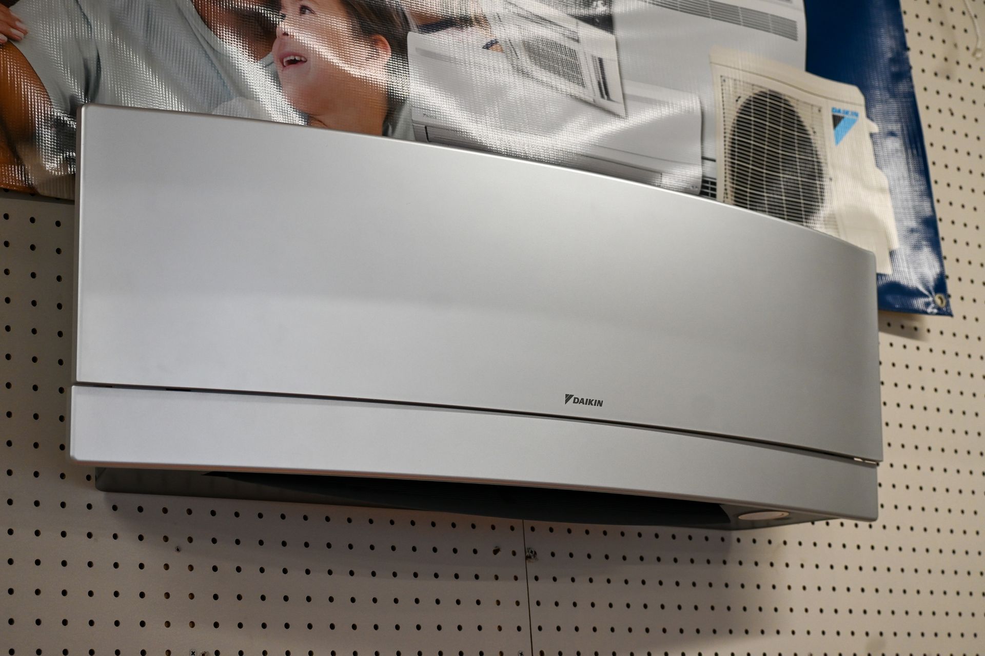 A white daikin air conditioner is hanging on a wall
