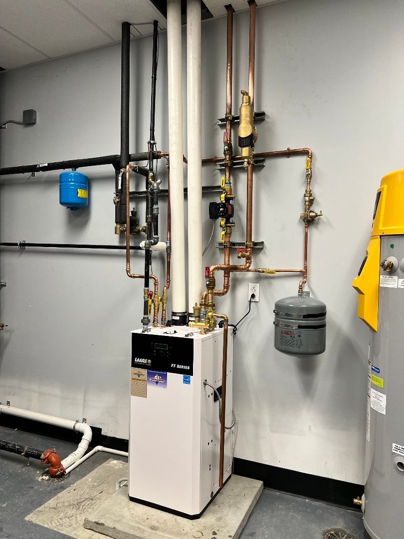 A room with a boiler and a water heater in it