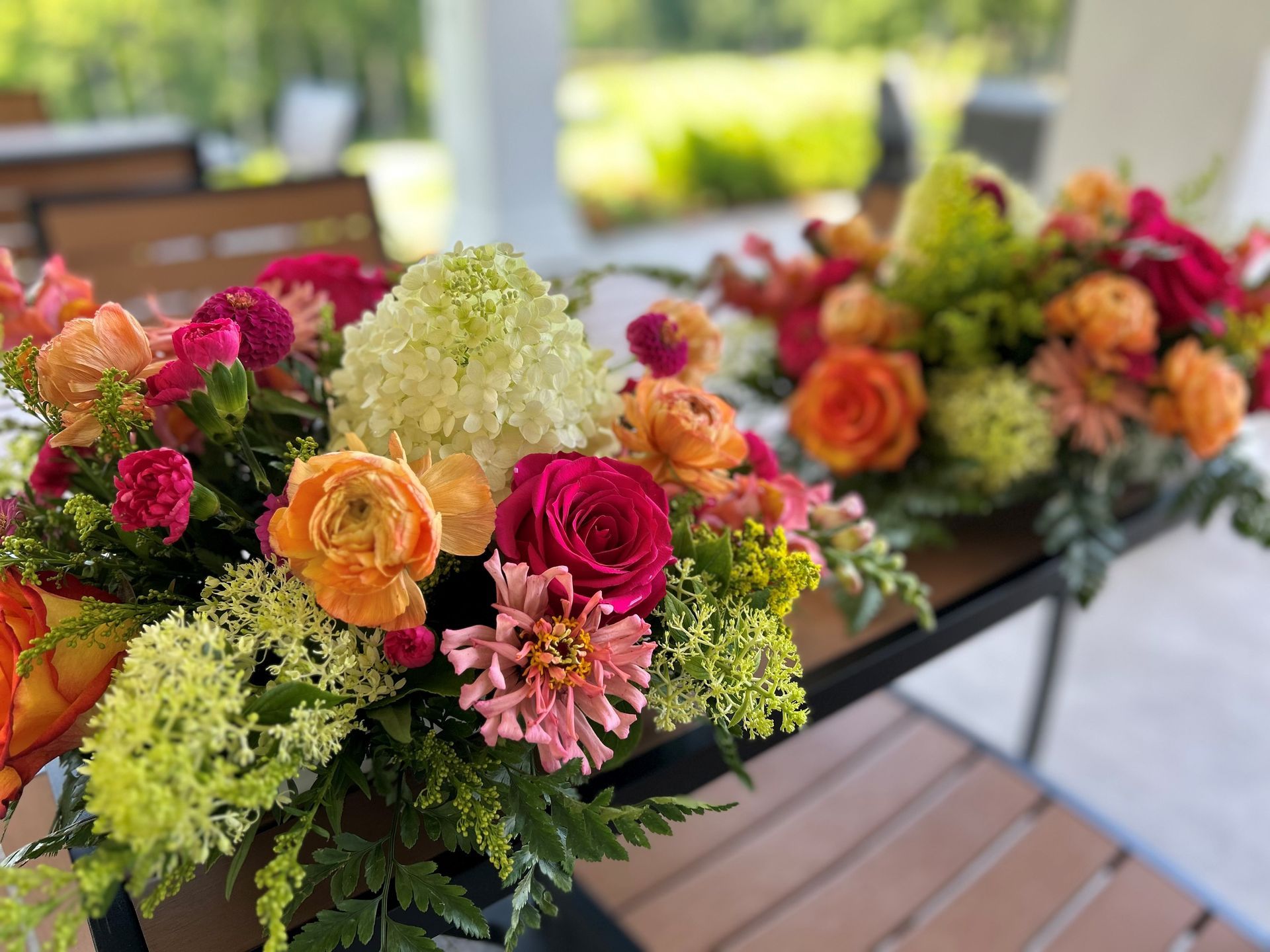 There are many Different Types of Flowers on the table  — Jasper, IN — Green Thumb Landscaping and Garden Center 