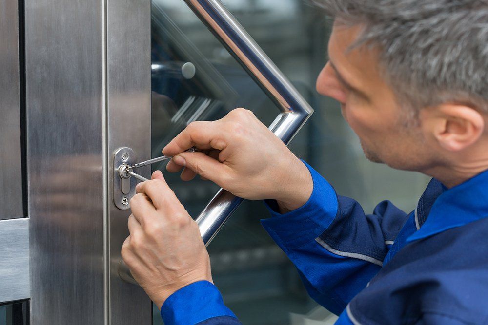 Male Lockpicker Fixing Door Handle at the Office | Garden City, KS | DJ’s Lock & Key LLC