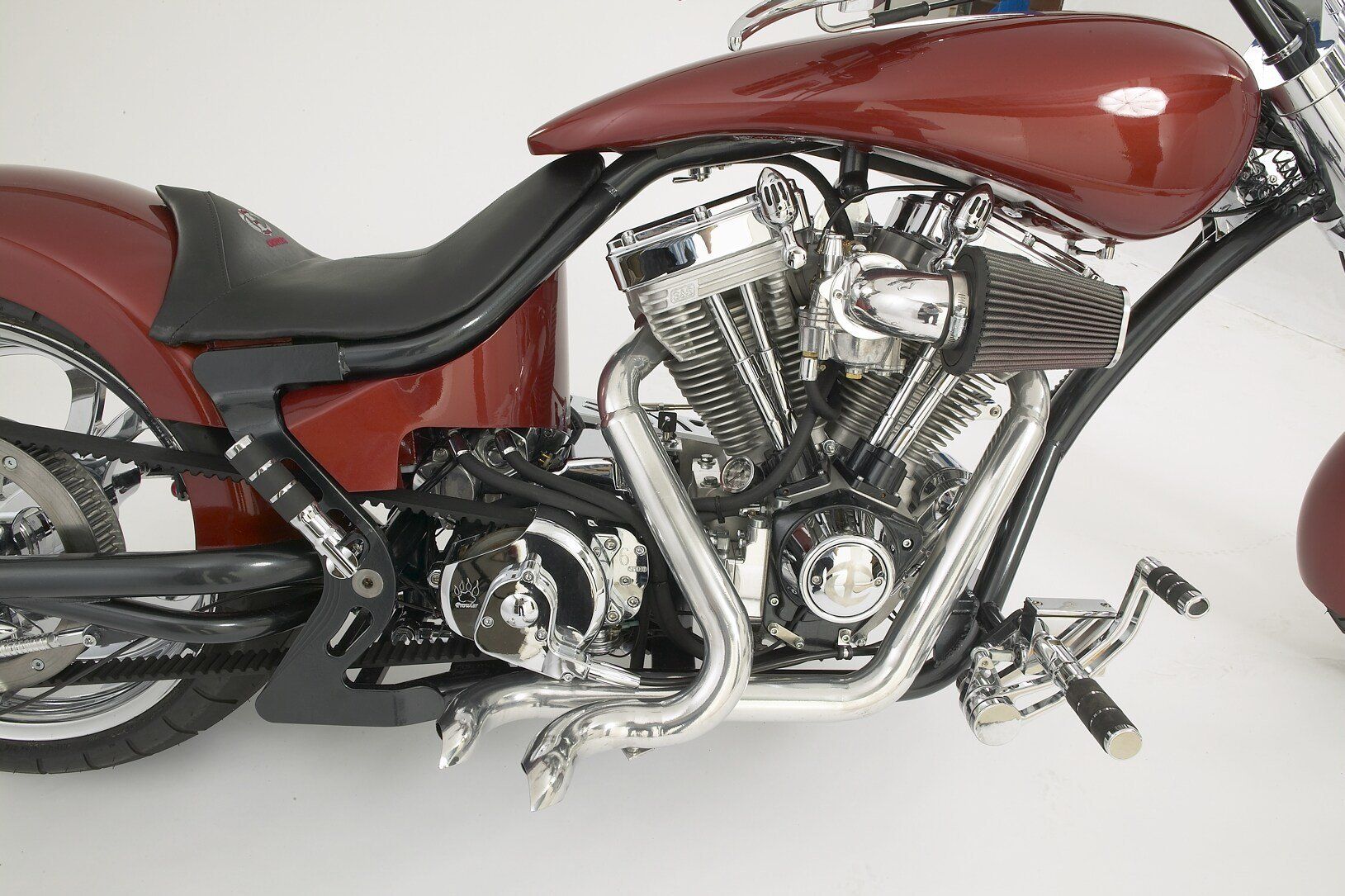 A close up of a red motorcycle on a white background