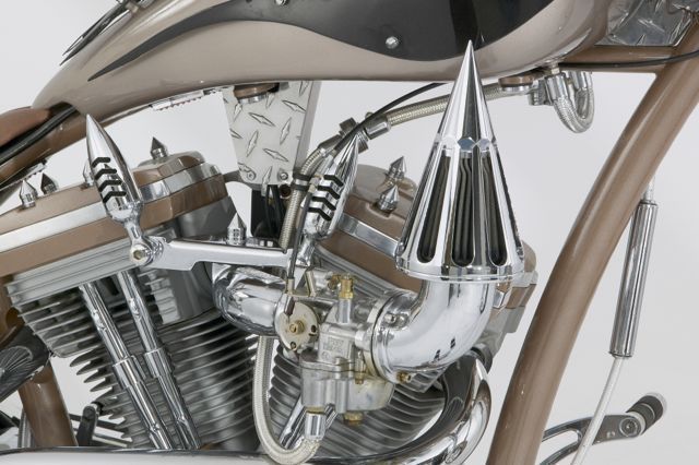 A close up of a motorcycle engine with spikes on it