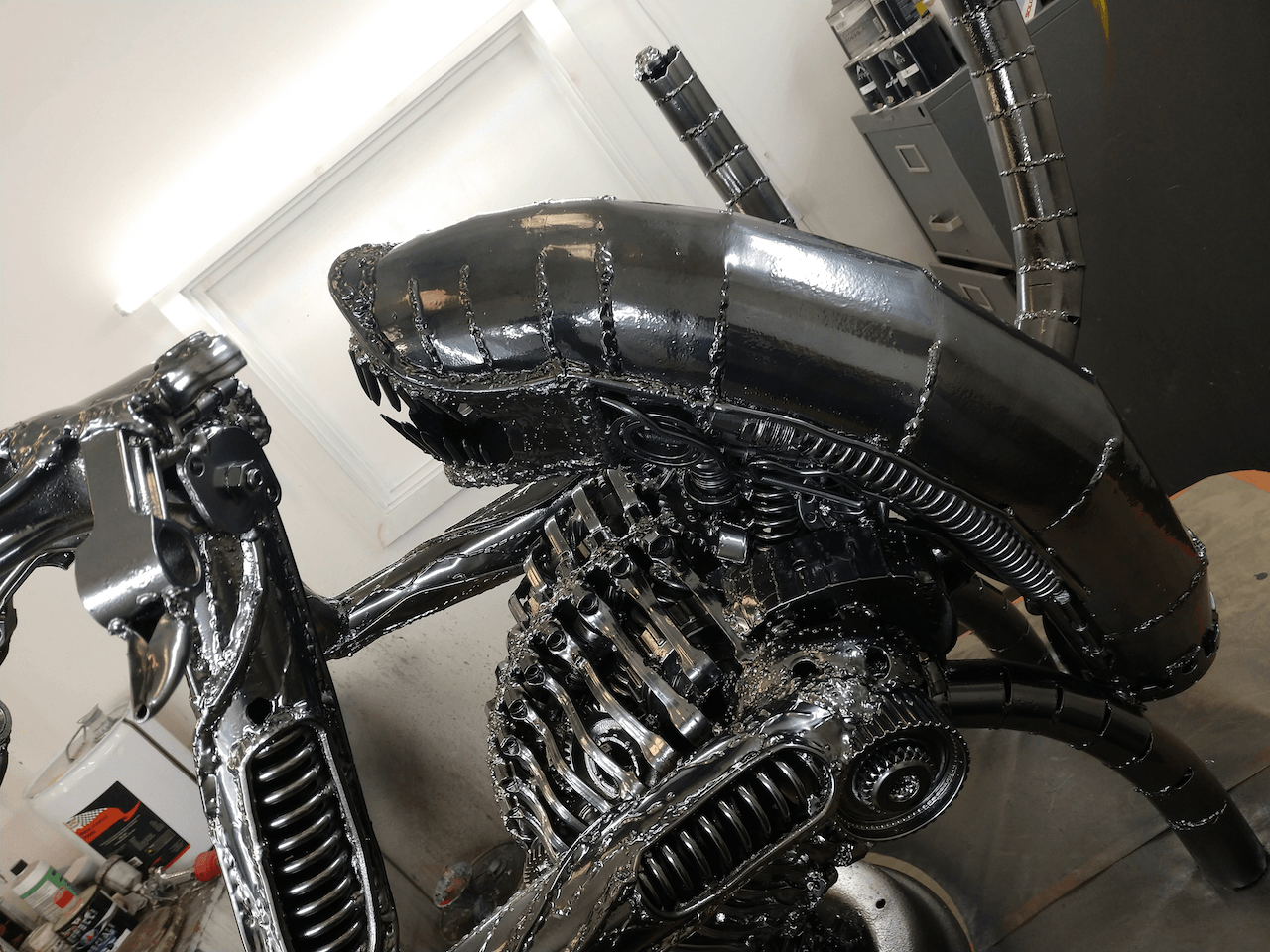 A statue of an alien is sitting in a room